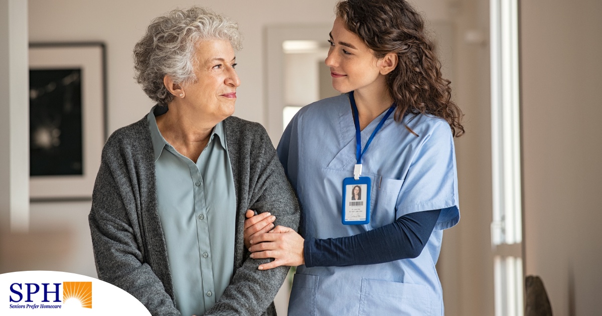 A caregiver and client smile at each other as the caregiver helps the client, representing emotional intelligence in caregiving.