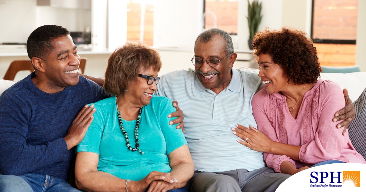 A couple sits with aging parents and enjoys their time together.