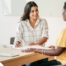 A woman smiles while being interviewed representing how well a caregiver interview can go when good questions are asked.